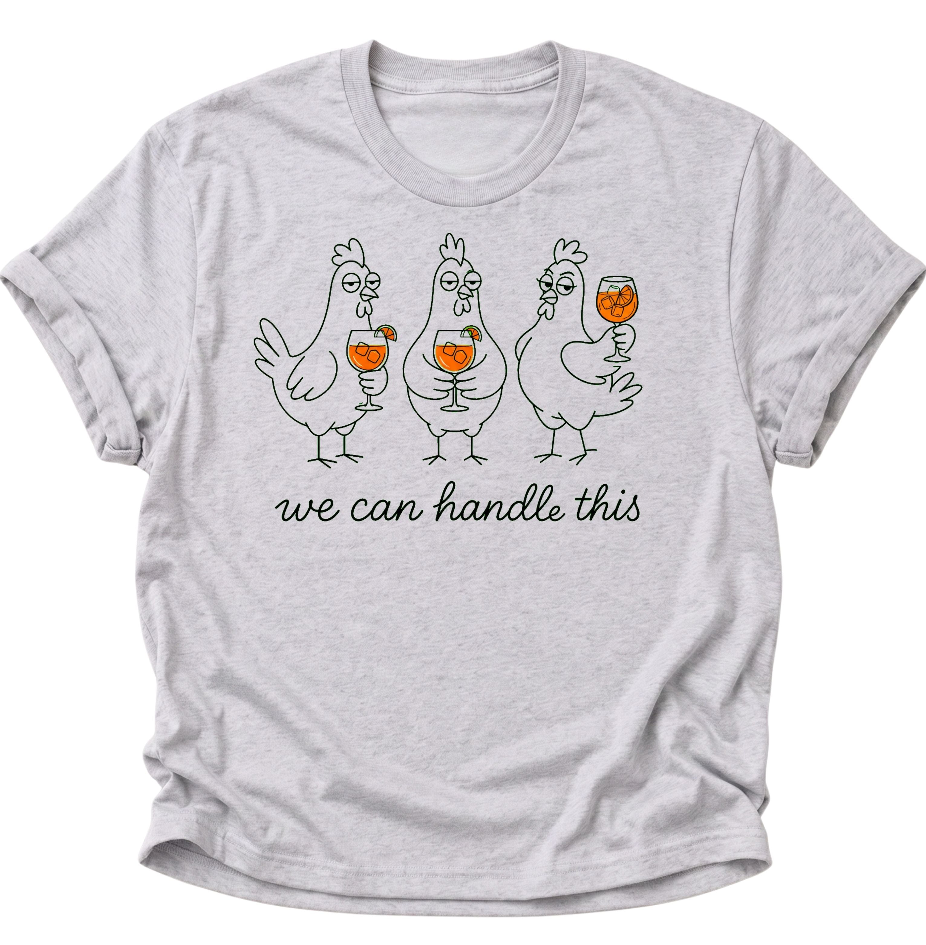 Ash Grey Unisex T-Shirt mit drei Hühnern, orangefarbenen Getränken und „we can handle this“ von Pine & River.

